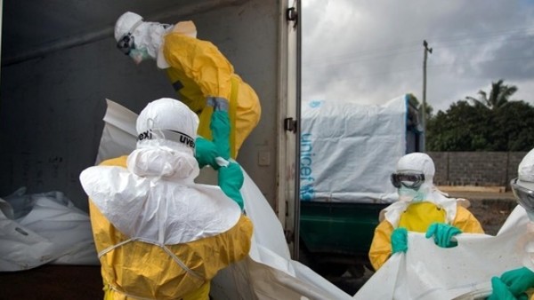 Ebola Workers Load Bodies