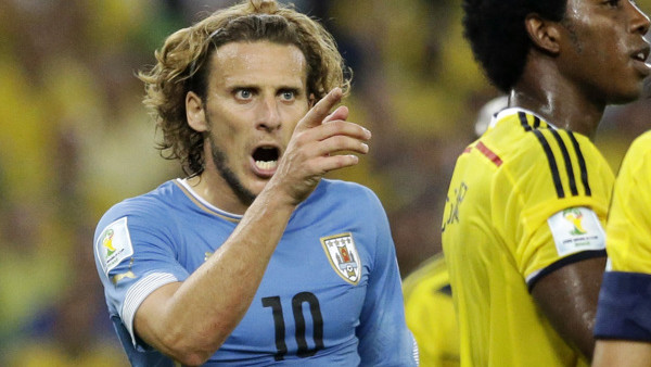 Uruguay's Diego Forlan, left, shouts at Colombia's Mario Yepes during the World Cup round of 16 soccer match between Colombia and Uruguay at the Maracana Stadium in Rio de Janeiro, Brazil, Saturday, June 28, 2014. (AP Photo/Matt Dunham)