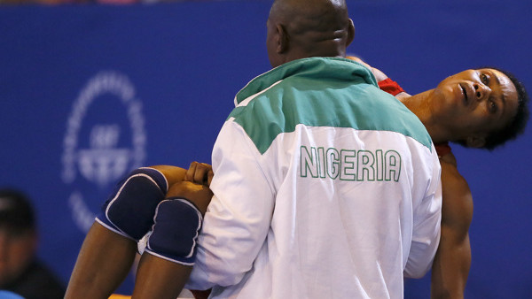 Ifeoma Nwoye of Nigeria is carried off after being beaten by Brittanee Laverdure of Canada in the women's FS 55kg semifinal wrestling bout at the Scottish Exhibition Conference Centre during the Commonwealth Games 2014 in Glasgow, Scotland, Thursday July 