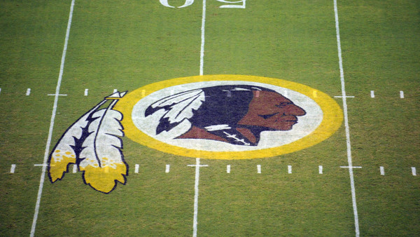 FILE - In this Aug. 28, 2009 file photo, the Washington Redskins logo is shown on the field before the start of a preseason NFL football game against the New England Patriots in Landover, Md. A long-running dispute over the Washington Redskins team name w