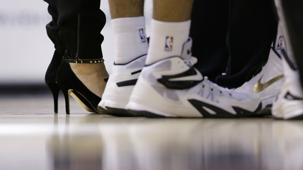 San Antonio Spurs assistant coach Becky Hammon, left, stands with Spurs players during a time out in the second half of an NBA basketball game against the Atlanta Hawks, Wednesday, Nov. 5, 2014, in San Antonio. Hammon is the first female to serve as a ful