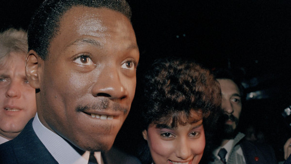 Comic actor Eddie Murphy and his girlfriend, Lisa Figueroa, smile at the premiere party for 