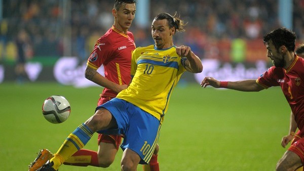 Sweden's Zlatan Ibrahimovic, center challenges for the ball with Montenegro's Zarko Tomasevic during the Euro 2016 Group G qualifying soccer match between Montenegro and Sweden, at the City Stadium in Podgorica, Montenegro, Saturday, Nov. 15, 2014. (AP Ph