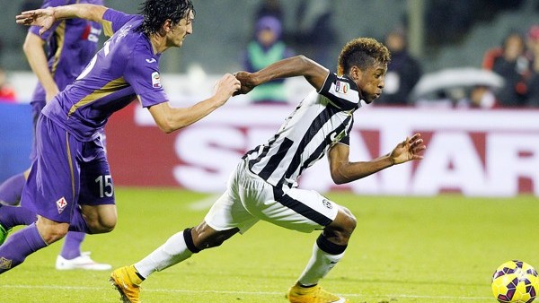 Fiorentina's Stefan Savic runs after Juventus' Kingsley Coman during a Serie A soccer match at the Artemio Franchi stadium in Florence, Italy , Friday Dec. 5 2014. (AP Photo/Fabrizio Giovannozzi)