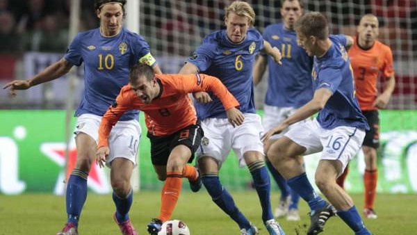 Rafael van der Vaart of the Netherlands, center, is challenged by Zlatan Ibrahimovic, Ola Toivonen, and Pontus Wernbloom of Sweden during their Euro 2012 Group E qualifying soccer match at ArenA stadium in Amsterdam, Netherlands, Tuesday Oct. 12, 2010. Th