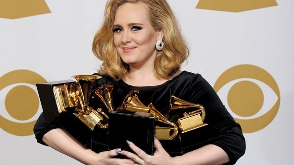Adele poses backstage with her six awards at the 54th annual Grammy Awards on Sunday, Feb. 12, 2012 in Los Angeles. Adele won awards for best pop solo performance for