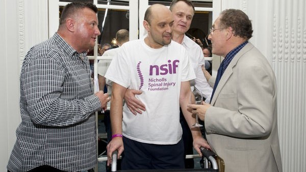 (left to right) Conrad Wolkowinski, Darek Fidyka, Stefan Okurowski (Darek's physio) and Professor Geoffrey Raisman (who treated Darek) attend the Nicholls Spinal Injury Foundation reception, Mandarin Oriental Hotel, Central London.