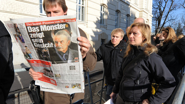Journalists and visitors, seen, in front of the entrance to the country court, in St. Poelten, Austria, Wednesday, March 18, 2009. The trial against Josef Fritzl who is accused of imprisoning his daughter for 24 years and fathering seven children with her