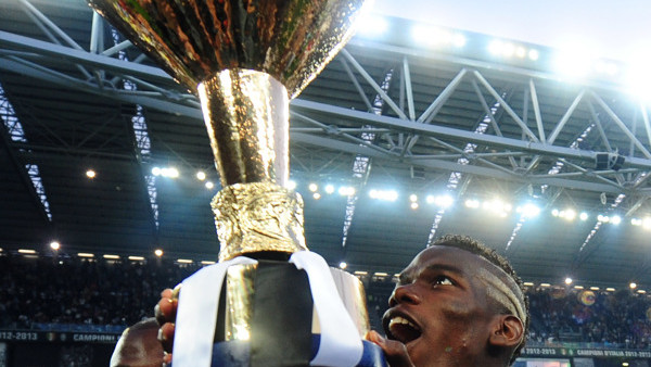 Juventus French forward Paul Pogba holds up the trophy after winning the Serie A soccer league title, at the end of a match between Juventus and Cagliari at the Juventus Stadium in Turin, Italy, Saturday, May 11, 2013. Newly-crowned champion Juventus was 