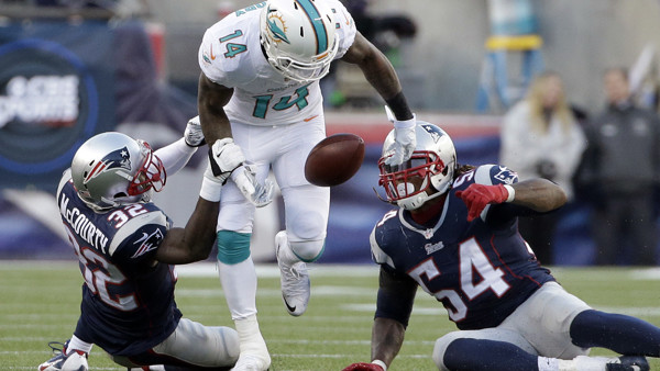 New England Patriots quarterback Tom Brady, left, celebrates with head coach Bill Belichick after defeating the Miami Dolphins 41-13 in an NFL football game Sunday, Dec. 14, 2014, in Foxborough, Mass. (AP Photo/Charles Krupa)
