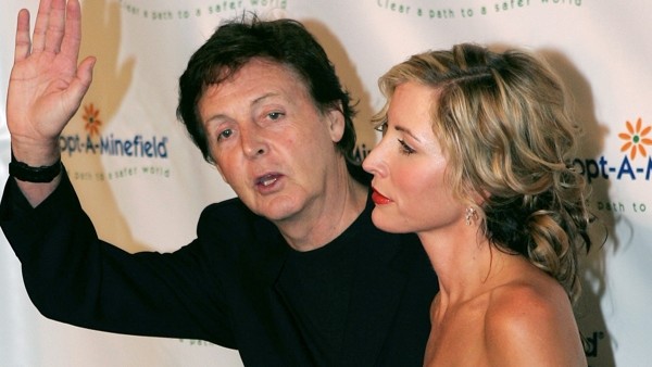 **FILE** In this Oct. 15, 2004 file photo, singer Sir Paul McCartney, with his wife Heather Mills McCartney, waves to photographers, as they arrive for the 4th Annual Adopt-A-Minefield gala, in Los Angeles. Justice Hugh Bennett granted a preliminary divor