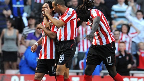 Sunderland's Kieran Richardson (left) celebrates scoring his sides first goal of the game with teammates Anton Ferdinand (center) and Kenwyne Jones (right)