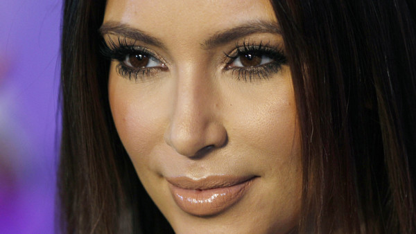 FILE - In this Oct. 4, 2012 file photo, television personality Kim Kardashian poses for photographers at the red carpet during the 40th anniversary of Cosmopolitan magazine in Spanish in Mexico City. Kim Kardashian has waded into the unlikely waters of Sy