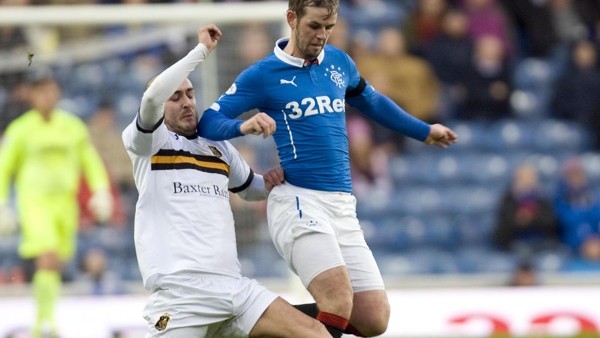Rangers David Templeton and Dumbarton's Scott Linton battle for the ball during the Scottish Championship match at Ibrox, Glasgow.
