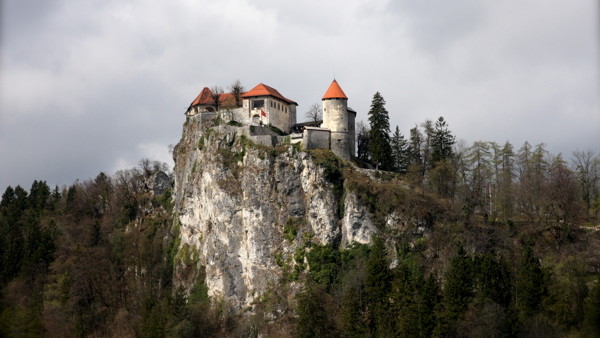In this photo taken Tuesday, Jan. 27, 2015, shows Lake Bled in Slovenia with a island and the Church of Our Lady on it. Tucked in the southwestern corner of Slovenia, between Austria and Italy, stands a spectacular landscape: a lush tiny island in the mid