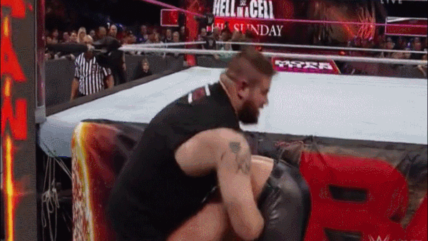 Kevin Owens Powerbomb Seth Rollins On Barricade