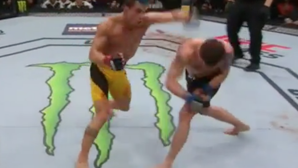 Miesha Tate, left, celebrates victory over Holly Holm in their UFC 196 womens bantamweight mixed martial arts match, Saturday, March 5, 2016, in Las Vegas. (AP Photo/Eric Jamison)